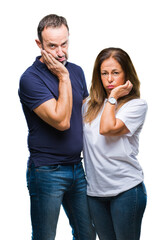 Wall Mural - Middle age hispanic casual couple over isolated background thinking looking tired and bored with depression problems with crossed arms.