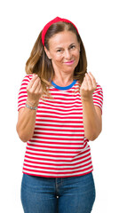 Sticker - Beautiful middle age woman wearing casual stripes t-shirt over isolated background Doing money gesture with hand, asking for salary payment, millionaire business