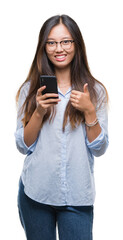 Poster - Young asian woman texting using smartphone over isolated background happy with big smile doing ok sign, thumb up with fingers, excellent sign