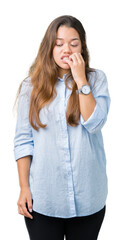 Sticker - Young beautiful brunette business woman over isolated background looking stressed and nervous with hands on mouth biting nails. Anxiety problem.