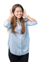 Sticker - Young beautiful brunette business woman over isolated background Trying to hear both hands on ear gesture, curious for gossip. Hearing problem, deaf