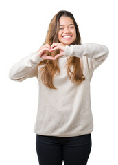 Canvas Print - Young beautiful brunette woman wearing turtleneck sweater over isolated background smiling in love showing heart symbol and shape with hands. Romantic concept.