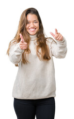 Sticker - Young beautiful brunette woman wearing turtleneck sweater over isolated background pointing fingers to camera with happy and funny face. Good energy and vibes.