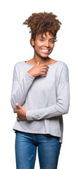 Wall Mural - Beautiful young african american woman over isolated background looking confident at the camera with smile with crossed arms and hand raised on chin. Thinking positive.