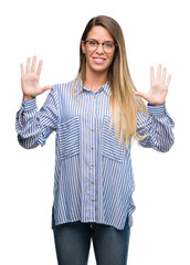 Sticker - Beautiful young woman wearing elegant shirt and glasses showing and pointing up with fingers number ten while smiling confident and happy.