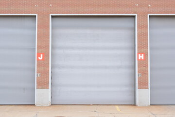 Large industrial loading dock doors on brick warehouse