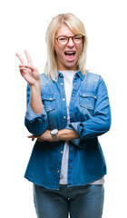 Sticker - Young beautiful blonde woman wearing glasses over isolated background smiling with happy face winking at the camera doing victory sign. Number two.