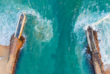 Aerial View Of Strong Current Pushing The Sea Between Coastal Breakwaters