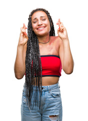 Wall Mural - Young braided hair african american with pigmentation blemish birth mark over isolated background smiling crossing fingers with hope and eyes closed. Luck and superstitious concept.