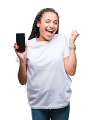 Sticker - Young braided hair african american girl showing screen of smartphone over isolated background screaming proud and celebrating victory and success very excited, cheering emotion