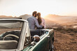 © Stefanie - Couple enjoying a romantic moment and hugging at sunset on mountain pass with a view. Franschhoek Pass, South Africa