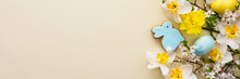 Festive Banner With Spring Flowers And Naturally Colored Eggs And Easter Bunnies, White Daffodils And Cherry Blossom Branches On A Yellow Pastel Background