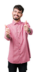 Young handsome man wearing pink shirt over isolated background approving doing positive gesture with hand, thumbs up smiling and happy for success. Looking at the camera, winner gesture.