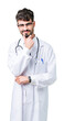 © Krakenimages.com - Young doctor man wearing hospital coat over isolated background looking confident at the camera with smile with crossed arms and hand raised on chin. Thinking positive.