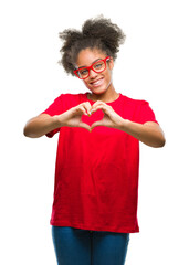 Wall Mural - Young afro american woman wearing glasses over isolated background smiling in love showing heart symbol and shape with hands. Romantic concept.