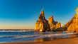 Sunset on the Portugal Ursa Beach, Praia da Ursa, 
the westernmost beach at atlantic coast of Atlantic Ocean with sand and sunset sun waves and foam at sand of coastline picturesque landscape panorama