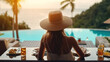 © Santy Hong - Dinner with sea view in luxury hotel. Woman in straw hat near swimming pool, eating food and enjoy ocean view. Dinner table on tropical vacation. Back view. Concept of travel, holidays, weekend.