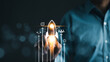 © Supatman - Rocket launch icon soars with speed to hit the growth target. Businessman is touching growing business. Planning and starting corporate business start up, Business goal and investment growth concept.