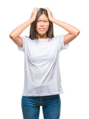 Poster - Young asian woman over isolated background suffering from headache desperate and stressed because pain and migraine. Hands on head.