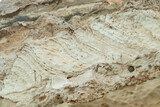 Fototapeta  - Pared de acantilado de roca sedimentaria en Las Negras, Almería, España. Pared afectada por la erosión marina en las costas de cabo de Gata en el mar Mediterráneo.