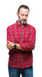 © Krakenimages.com - Middle age hoary senior man over isolated background skeptic and nervous, disapproving expression on face with crossed arms. Negative person.