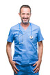 © Krakenimages.com - Middle age hoary senior doctor man wearing medical uniform over isolated background with a happy and cool smile on face. Lucky person.
