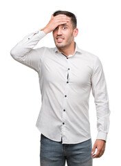 Wall Mural - Handsome young business man stressed with hand on head, shocked with shame and surprise face, angry and frustrated. Fear and upset for mistake.