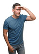 © Krakenimages.com - Handsome young casual man very happy and smiling looking far away with hand over head. Searching concept.