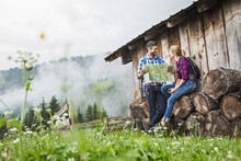 Glückliches Paar In Karohemden  Mit Landkarte An Einer Alm In Den Bergen, Österreich