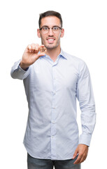 Sticker - Handsome young man holding bitcoin with a happy face standing and smiling with a confident smile showing teeth