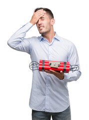 Poster - Handsome young business man holding an alarm clock bomb stressed with hand on head, shocked with shame and surprise face, angry and frustrated. Fear and upset for mistake.