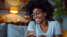 Smiling Young Beauty Black Curly Woman At Home Relaxed Texting Using Mobile Phone, Technology Communication Concept