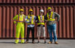 © Jack Tamrong - Photo group of diversity container worker men and pregnant manager standing in front of stack of container shipment yard