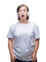 Sticker - Young adult woman with down syndrome wearing headphones over isolated background afraid and shocked with surprise expression, fear and excited face.