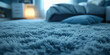 shaggy rug in a cozy, dimly lit bedroom. The rug's long, soft fibers are in a calming shade of light blue
