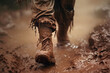 A foot in a muddy running shoe
