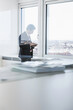 © Stefanie - business manager working in his office with a view