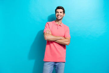 Portrait of smiling guy in pink t shirt folded hands looking novelty business opportunities bright future isolated on cyan color background