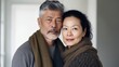 © iuricazac - European couple in their 50s hugs at home.