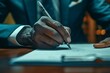 Professional businessperson signing crucial documents, close-up on hand with pen. Ideal for corporate, legal, and finance themes.