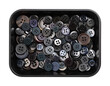 © Peter Hermes Furian - Plastic sew-through buttons, in a black plastic dish. Flat buttons with holes through which thread is sewn to attach the button. Fastener that joins two pieces of fabric together. Close-up from above.