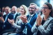 © Iftikhar alam - Group of People Clapping and Smiling in a Celebration of Joy and Success, Happy colleagues applauding while sitting in conference event at convention center business people sit together, AI Generated