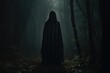 A person wearing a hooded cloak stands in the darkness of a forest, evoking an air of intrigue and secrecy, Hooded figure in the dark forest, AI Generated