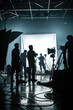 © thejokercze - Silhouette people working in studio with equipment and lighting for making movie or commercial