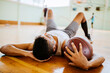 © Marko Geber - Young man taking a break from playing basketball in an indoor basketball gym