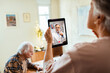 © Marko Geber - Senior woman having video call with doctor at home