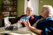 © Marko Geber - Senior couple having video call with doctor at home