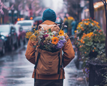 A Man Wearing A Backpack Full Of Different Flowers As A Gift For Valentine Day. Trip, Love, And Romantic Concept.