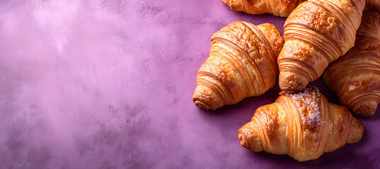 banner of croissants on the purple background