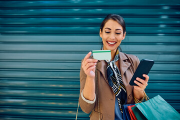 Sticker - Happy woman shopping with credit card and smart phone.